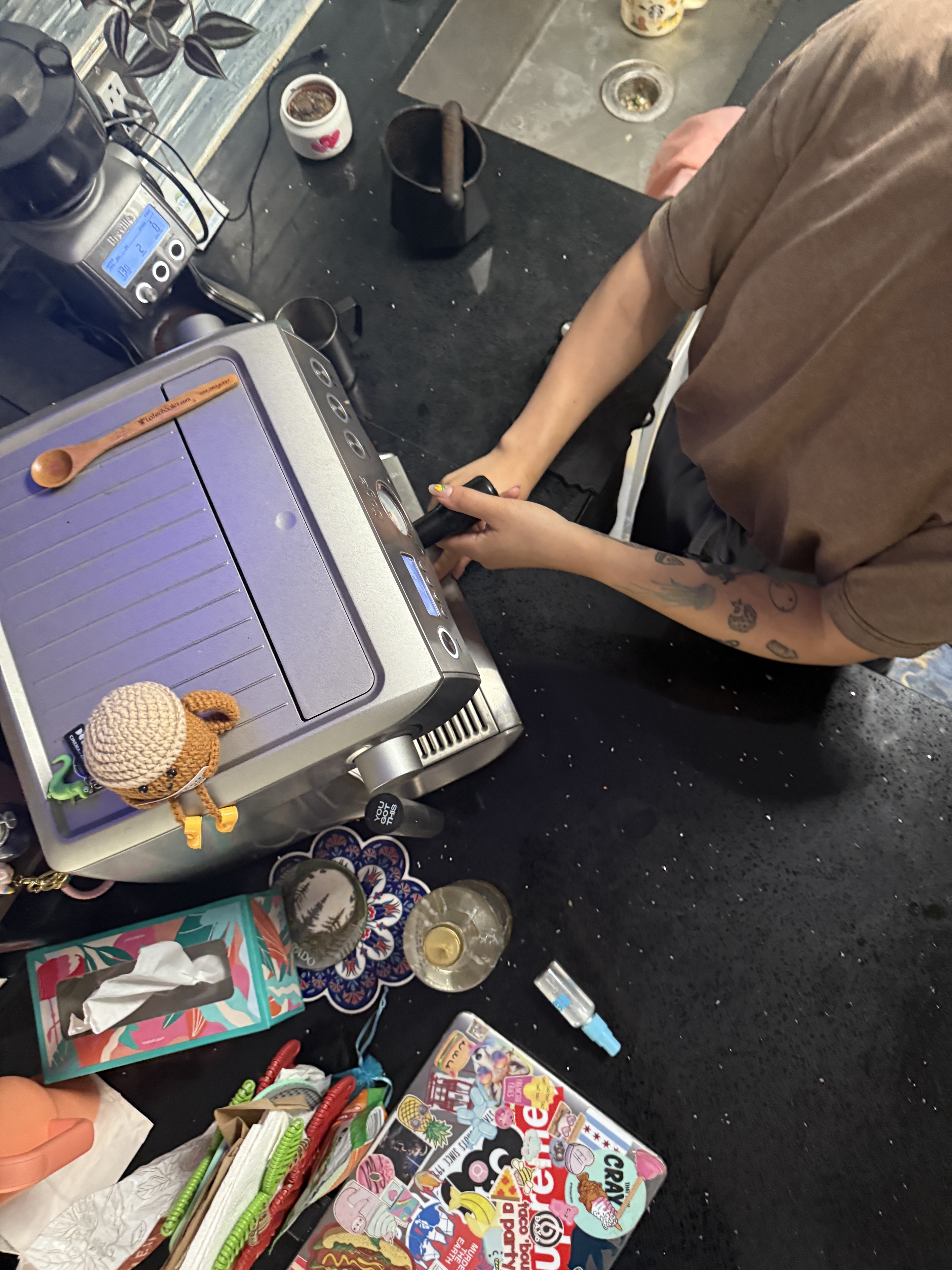 Overhead view of Bianca working at an espresso machine.