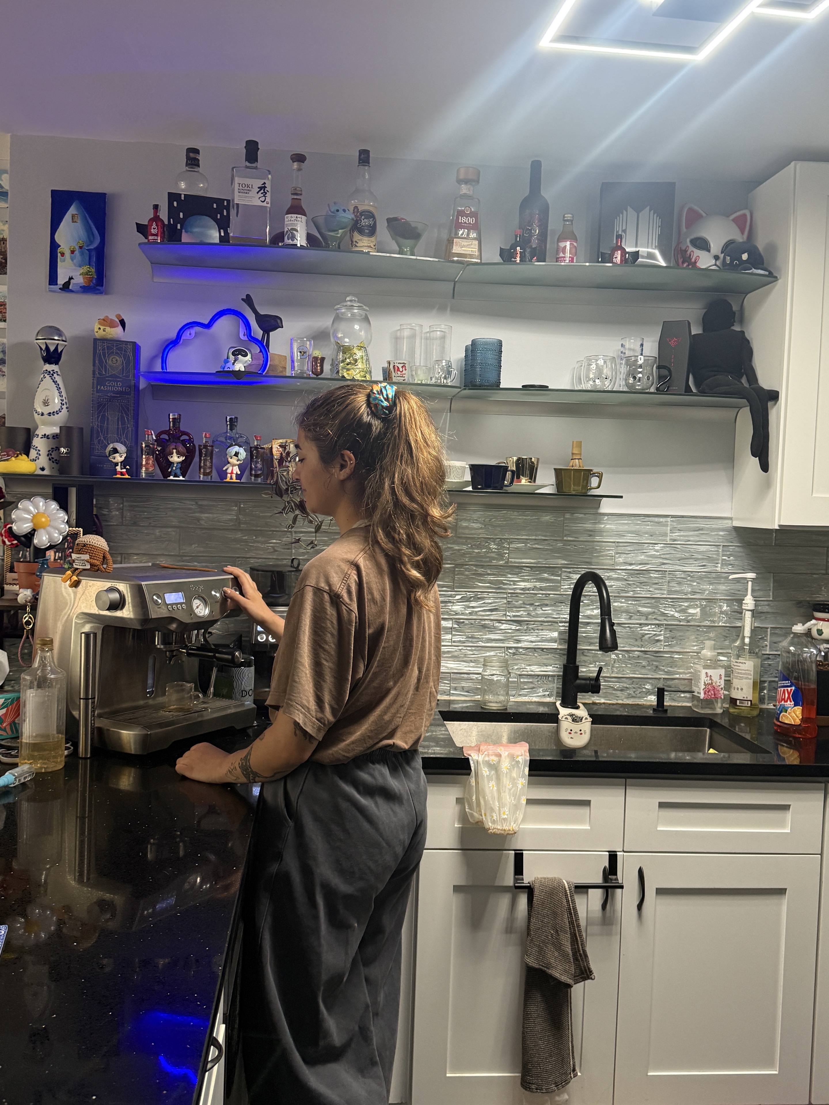Bianca Avram working with an espresso machine in a warm kitchen setting.